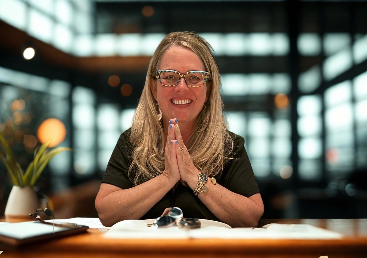 Betsy Kimmel, ICF Coach and E-RYT 500 Yoga Teacher in a professional setting.